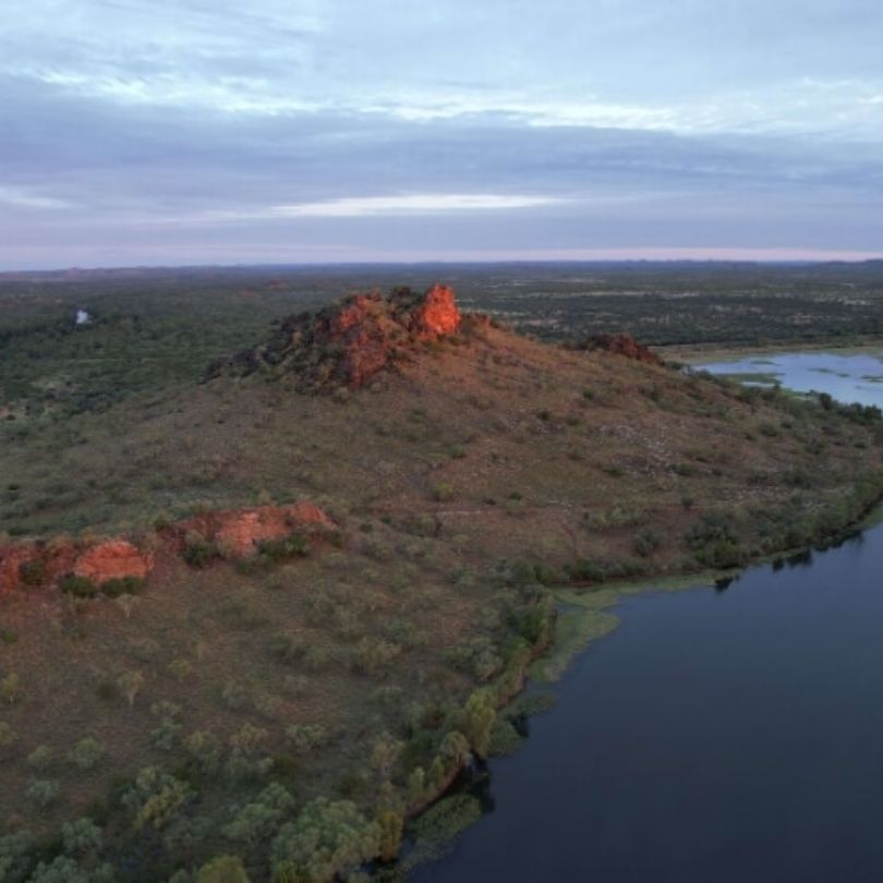 Chinamen CK Dam in Cloncurry. Sunsetting on the rocks overlooking the vast valley of dirt, trees, and the dam below.