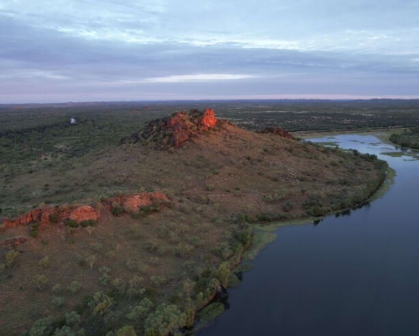 Chinamen CK Dam in Cloncurry. Sunsetting on the rocks overlooking the vast valley of dirt, trees, and the dam below.