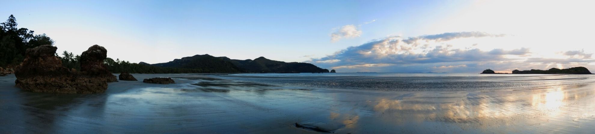 On the beach of Whitehaven (near Mackay) looking at the cloudy sky over the calm ocean.